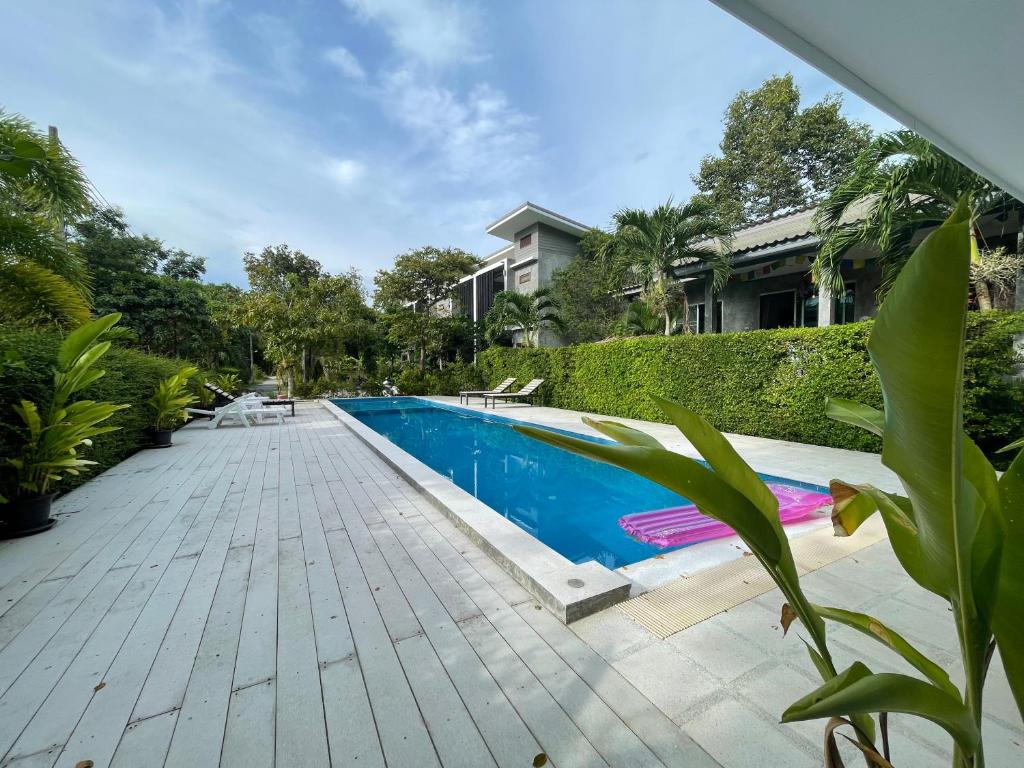 a swimming pool in front of a house at The Zohan Resort & Travel Agency in Wok Tum
