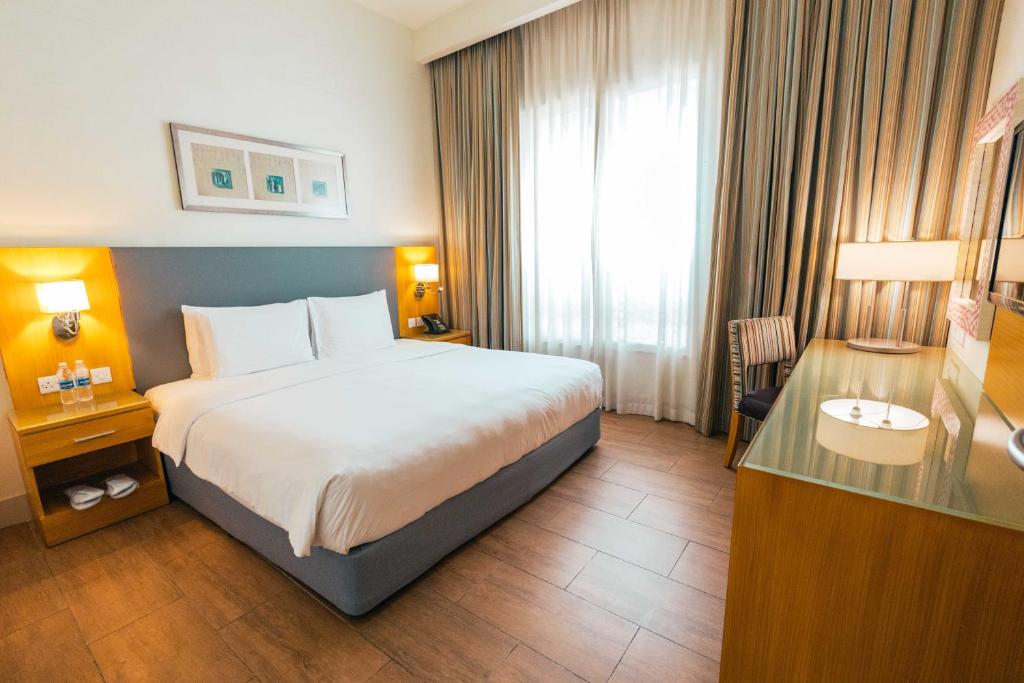 Postel nebo postele na pokoji v ubytování Salalah Gardens Hotel Managed by Safir Hotels & Resorts