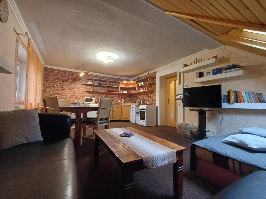 a living room with a couch and a table at Apartman Dolica in Smokovce