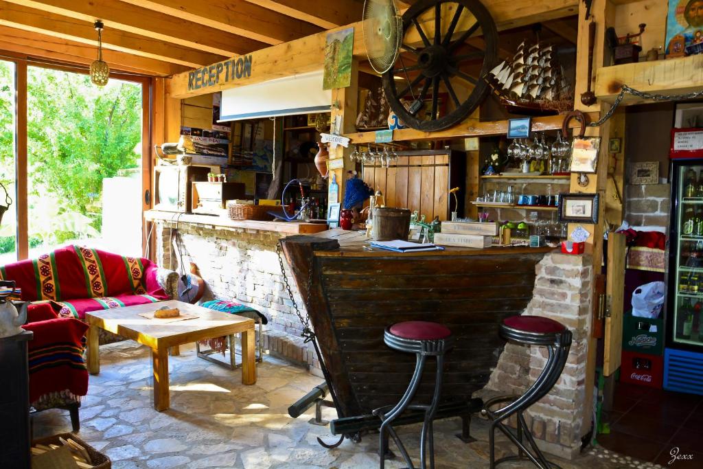 a bar with stools and a table in a room at Hostel Anton in Tivat