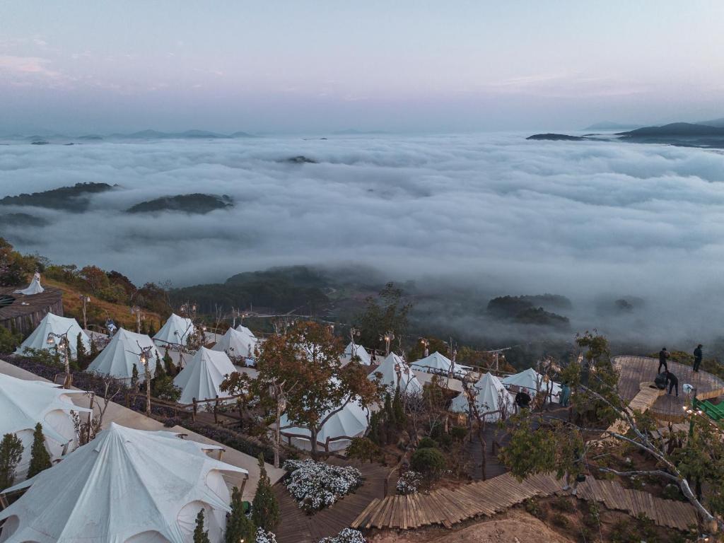 a group of white tents in a field of clouds at Cloud9 Glamping & Cafe in Xuân Trường