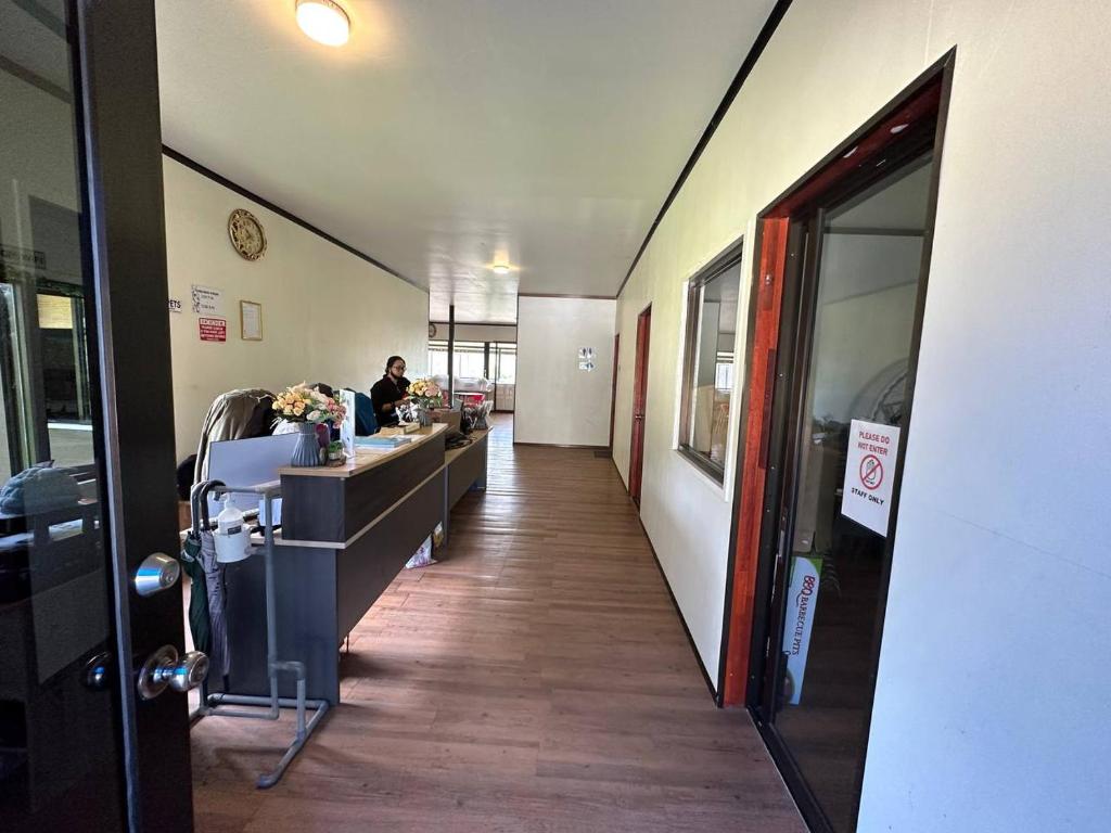 a hallway of an office with a man sitting at a desk at GEORGE ADVENTURE BASE BUNDU TUHAN 