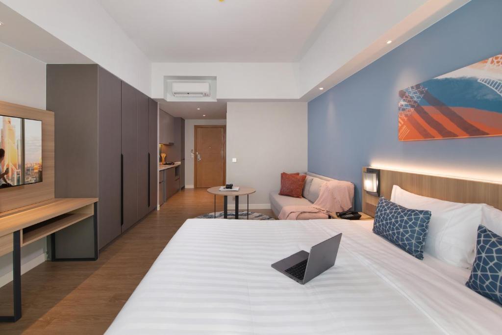 Postel nebo postele na pokoji v ubytování Citadines Roces Quezon City