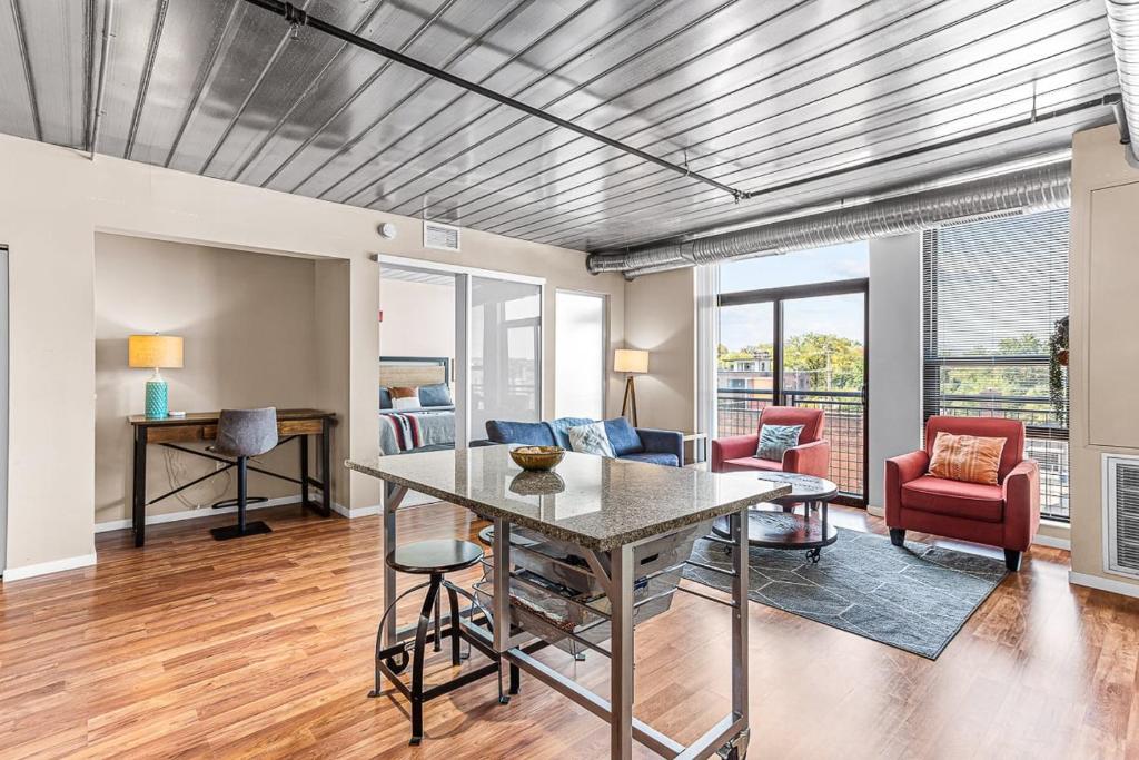 a living room with a table and chairs at Spacious 2 King Bed Downtown Central to it All in Ann Arbor