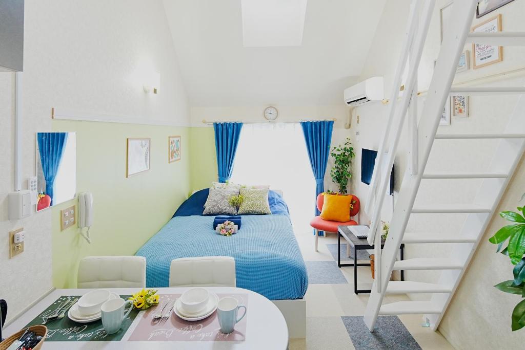 a small bedroom with a bed and a staircase at SC Heights 203 in Tokyo