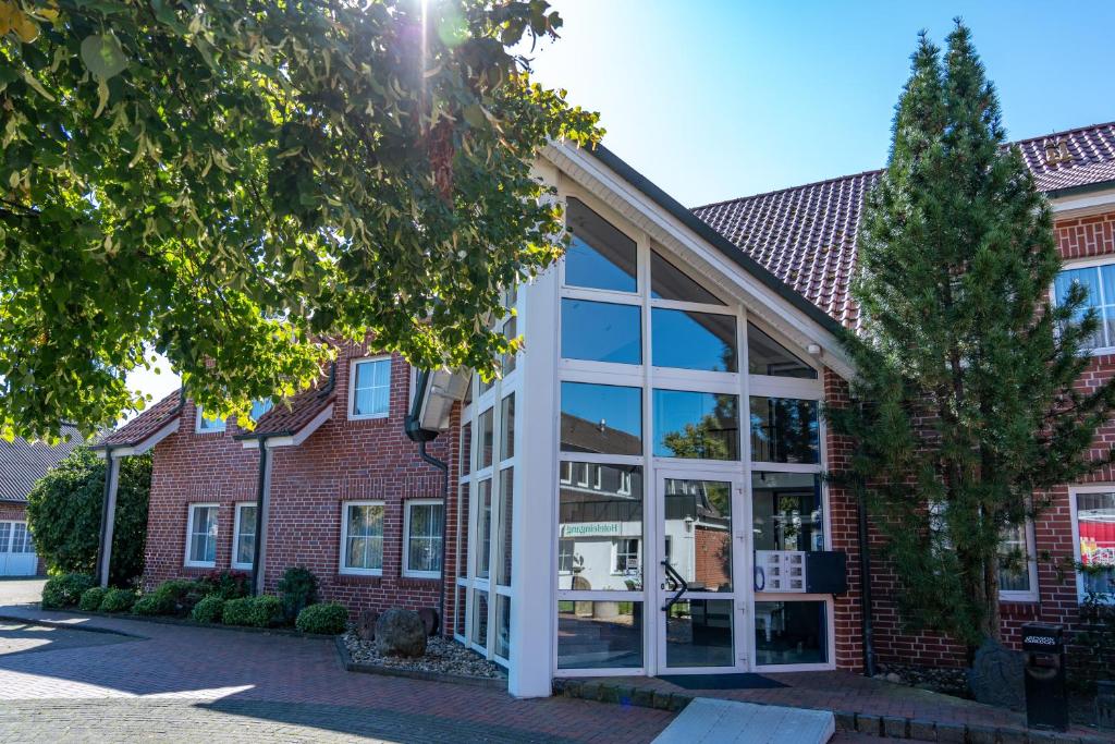a building with large glass windows in front of it at Landhotel Elkemann in Ahaus
