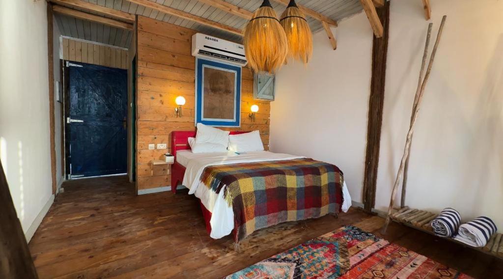 a bedroom with a bed in a room with wooden walls at Banan Beach in Ras al Khaimah