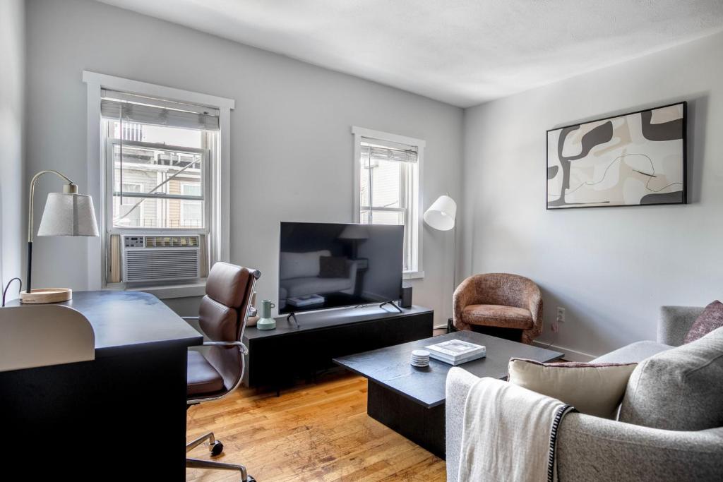 a living room with a couch and a tv at South Boston 2br w building wd nr seaport BOS-914 in Boston