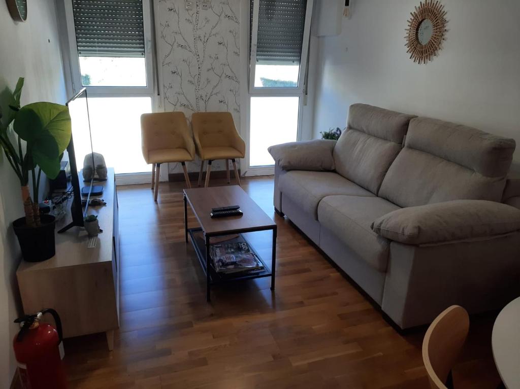 a living room with a couch and a coffee table at Apartamentos Parke24 San Sebastian by RUVA in Rentería