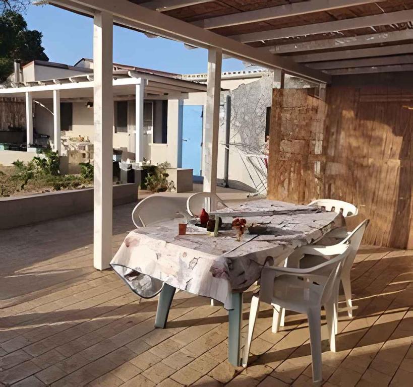 a table and chairs on a patio with a view of the ocean at Holiday home in Portopalo 35405 in Portopalo