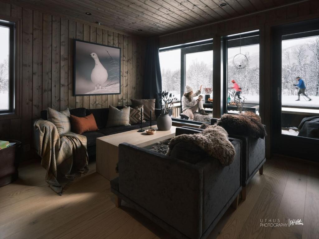 a living room with two couches and a table at Beautiful apartment - high standard - Geilo centre in Geilo