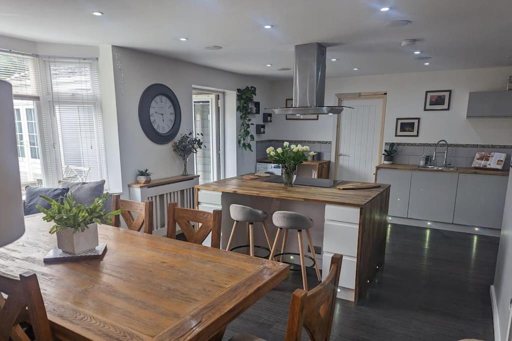 a kitchen and dining room with a wooden table and chairs at Apartment in Bournemouth, Dorset in Bournemouth