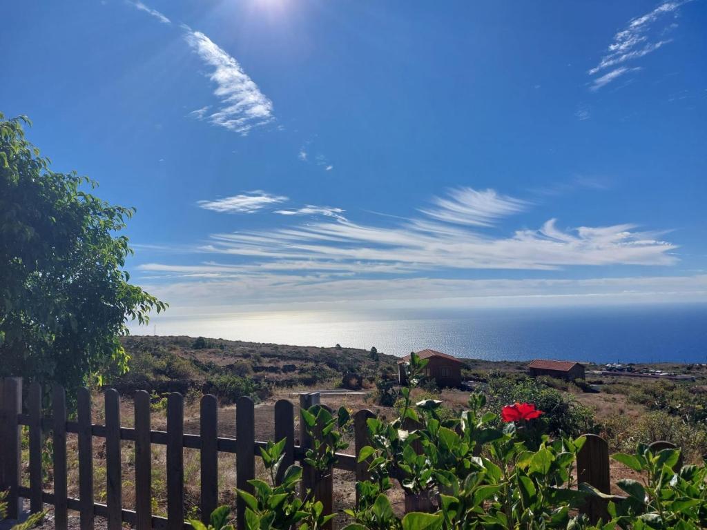 a view of the ocean from behind a fence at Las casitas de Pao in El Pinar del Hierro