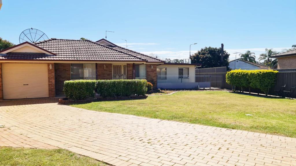 a house with a brick driveway in front of a yard at 3 Bed Room, Luxury Home in Schofields