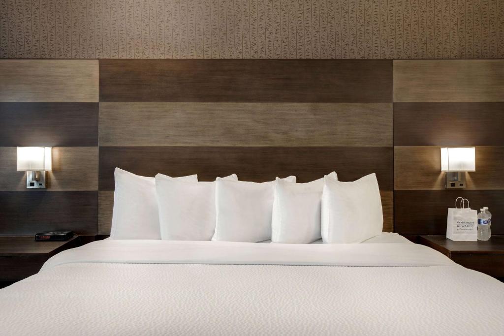 Säng eller sängar i ett rum på Days Inn by Wyndham Calgary South