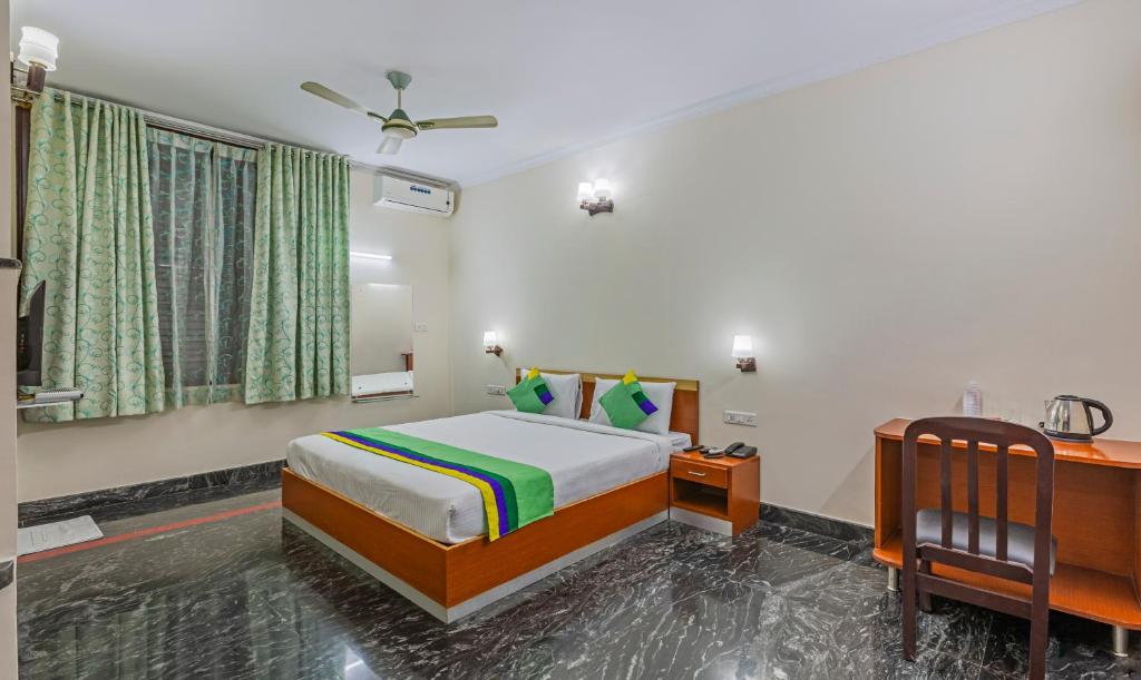 a bedroom with a bed and a desk at Treebo Trend Akshaya Residency in Bangalore