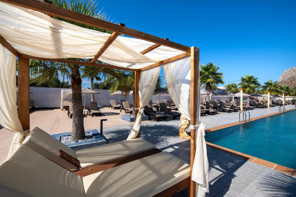 a canopy over a swimming pool at a resort at Paradice Hotel Luxury Suites-Near zorbas Beach-FREE Breakfast in Stavros