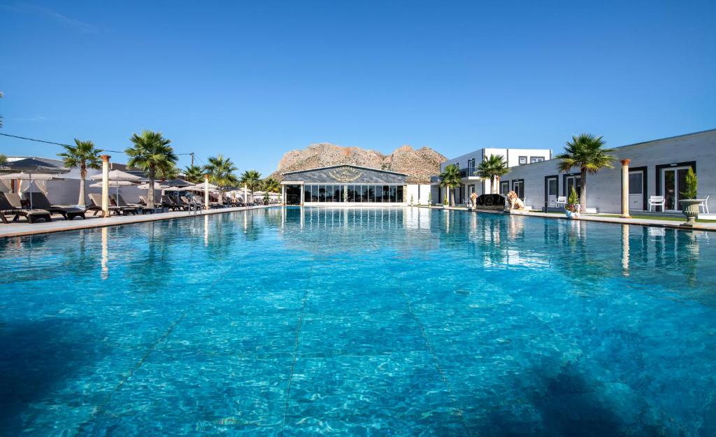 a large pool of blue water in a resort at Paradice Hotel Luxury Suites-Near zorbas Beach-FREE Breakfast in Stavros