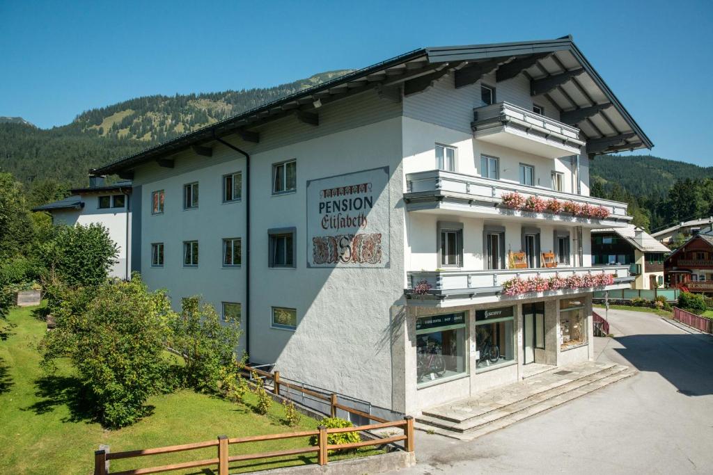 a large white building with a sign on it at Pension Elisabeth in Russbach am Pass Gschütt