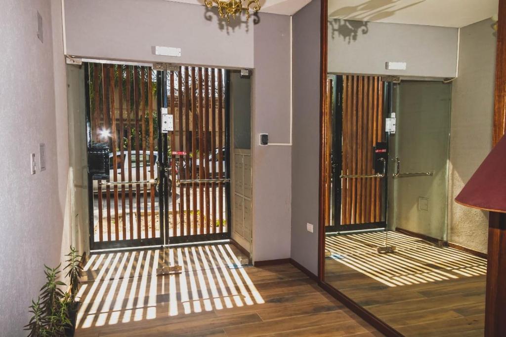 a hallway with a door with a wrought iron gate at Departamento de un dormitorio - SAN LORENZO in Santa Fe