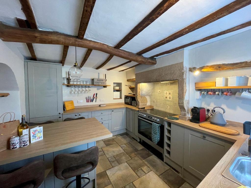 a kitchen with a wooden counter top in a room at Charming & Idyllic Grade 2 Listed Cottage for 6 Pass the Keys in Stony Middleton