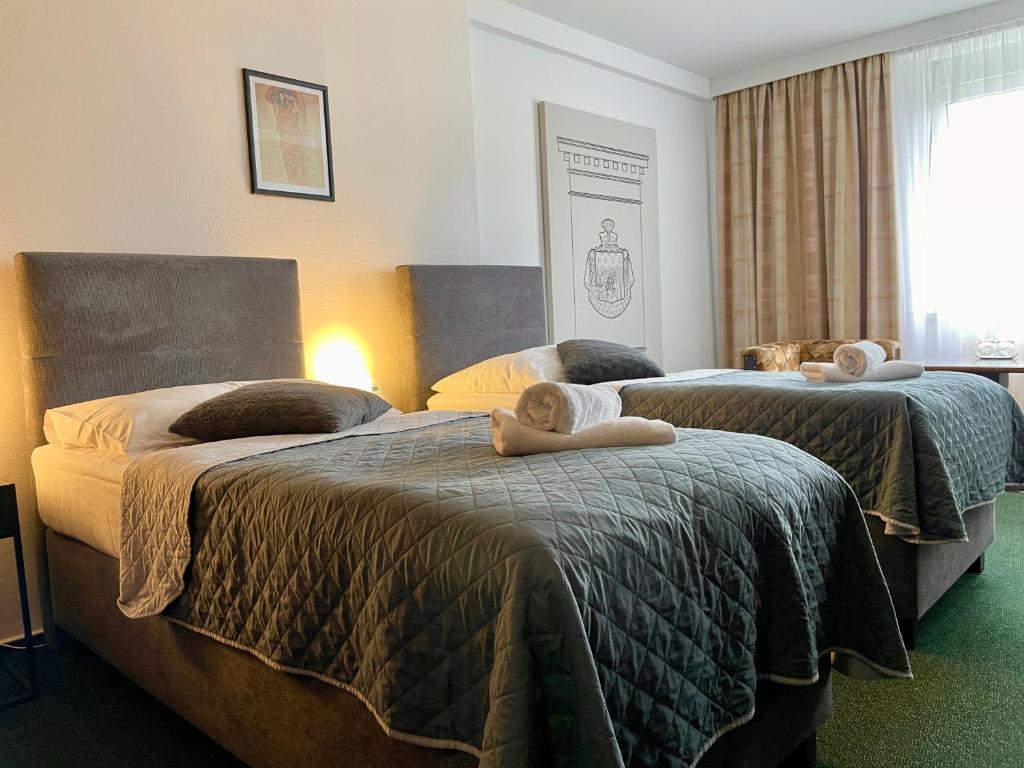 Postel nebo postele na pokoji v ubytování A-Austerlitz Hotel