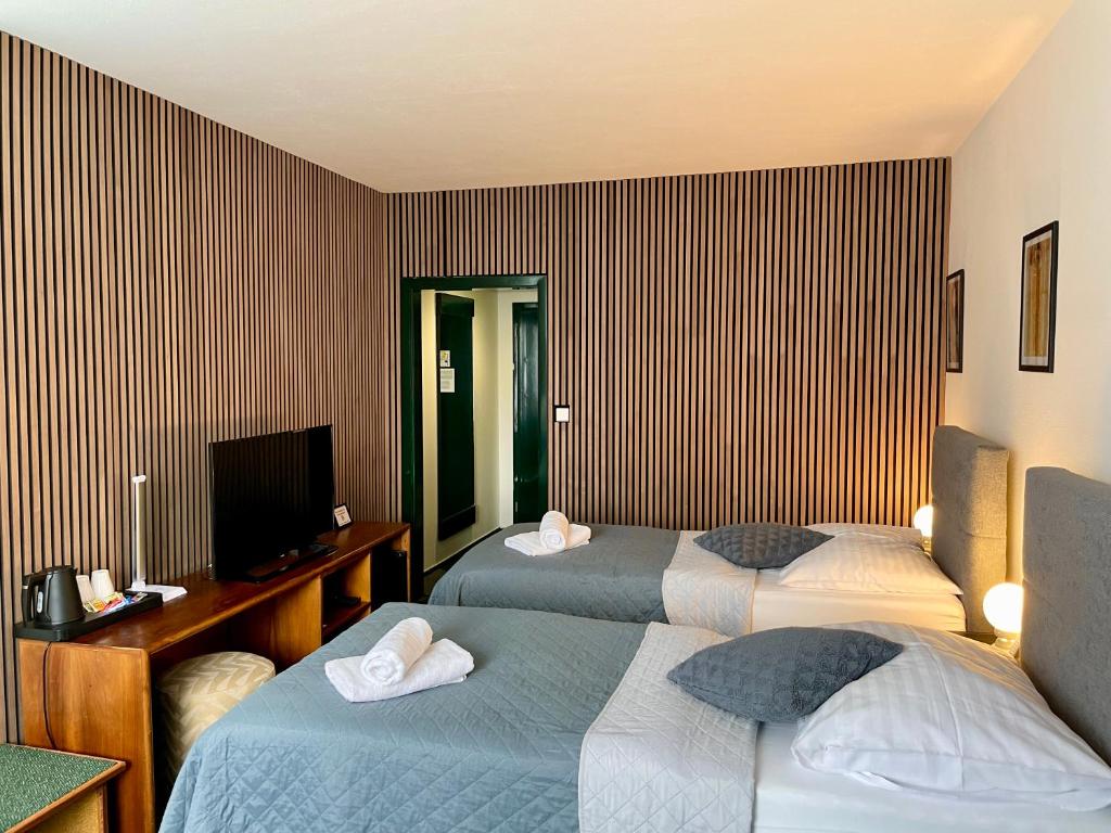 Postel nebo postele na pokoji v ubytování A-Austerlitz Hotel