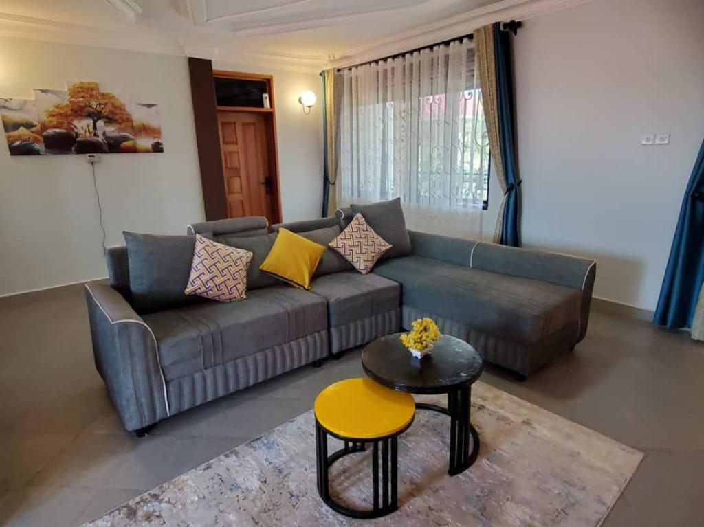 a living room with a couch and a table at cosy living in Gulu