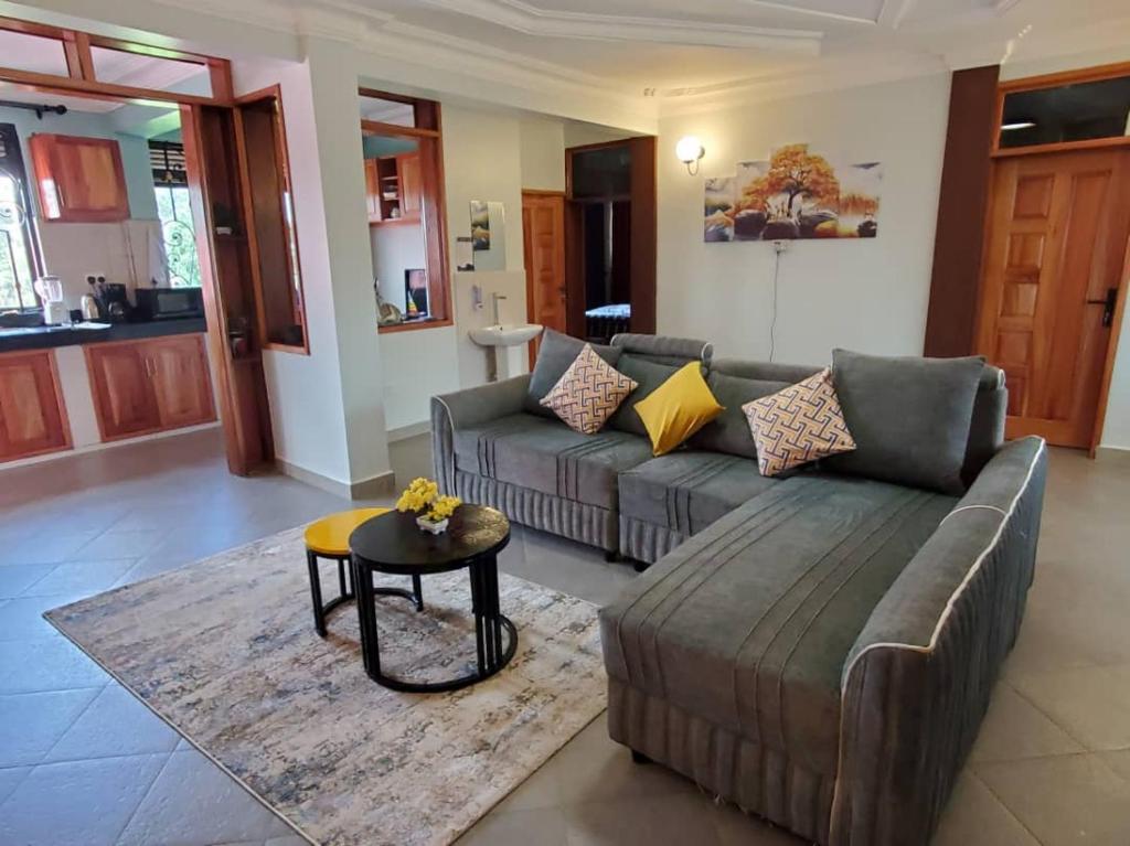 a living room with a couch and a table at Cosy Living in Gulu