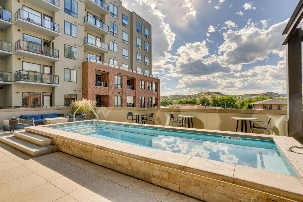 a swimming pool in front of a building at Castle Rock Condo - Walk to Dining and Shopping! in Castle Rock