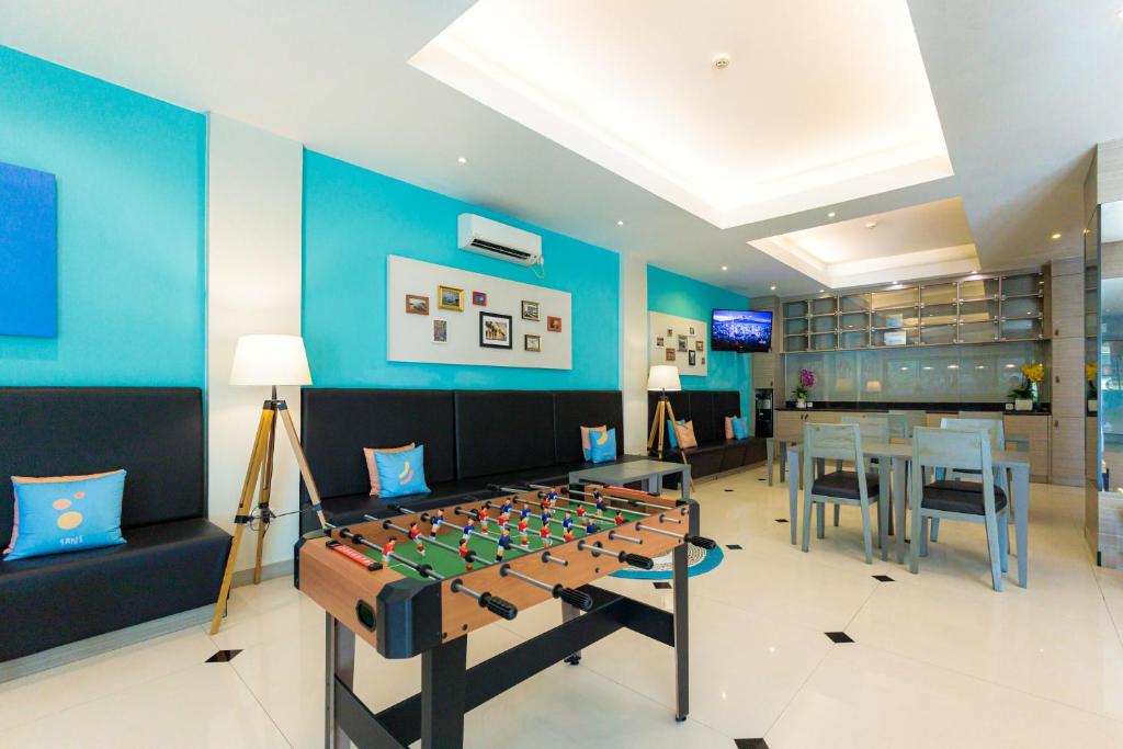 a room with a foosball table in the middle at Sans Hotel Liv Ancol by RedDoorz in Jakarta