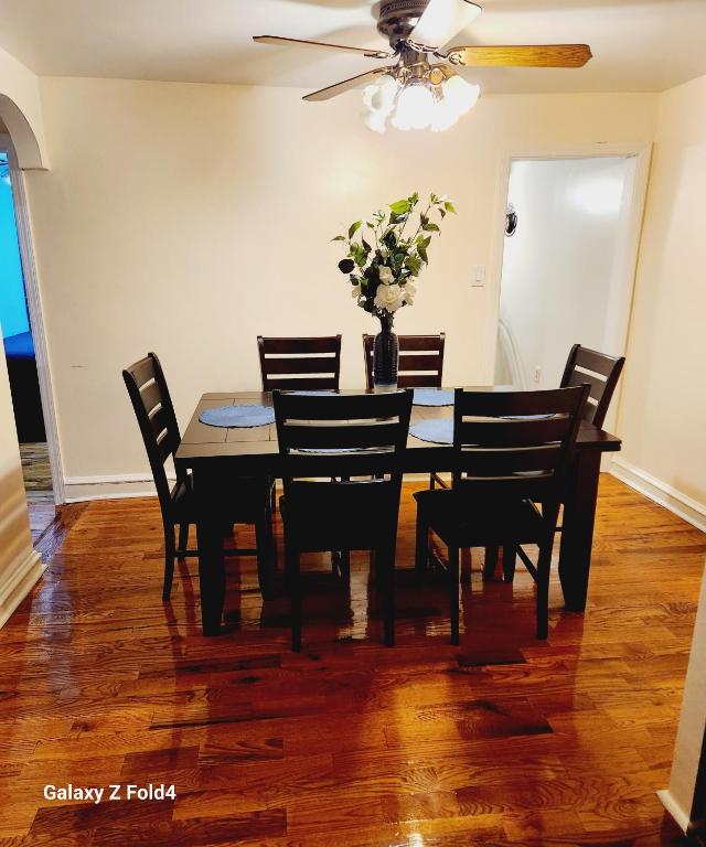 een eettafel met stoelen en een vaas met bloemen bij Cozy 1 Bedroom Business Suite in Philadelphia