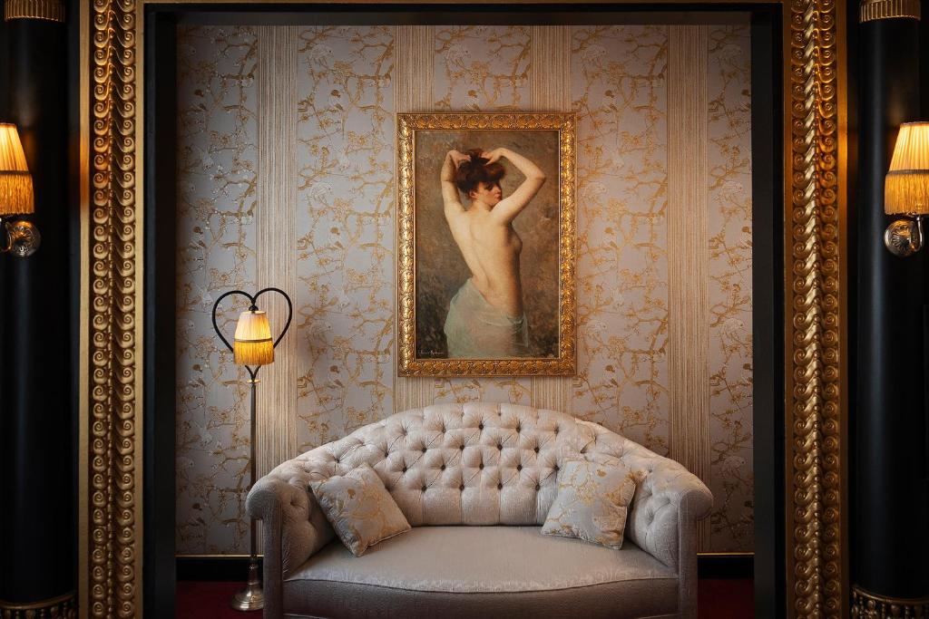 a painting of a woman in a room with a couch at Maison Souquet, Hotel & Spa in Paris
