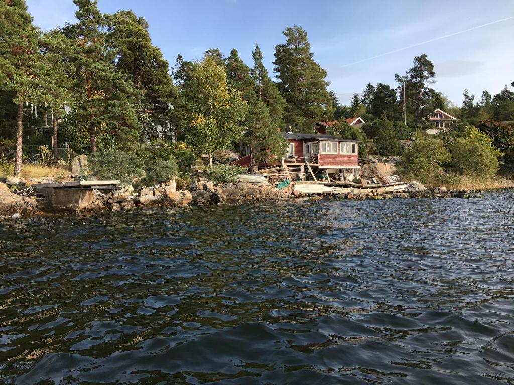 a house on the shore of a body of water at Sjöstuga, Archipelago Beach House in Värmdö