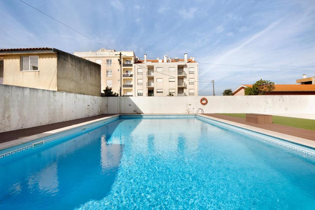 a swimming pool on the side of a building at Live Vagueira Beach in Praia da Vagueira