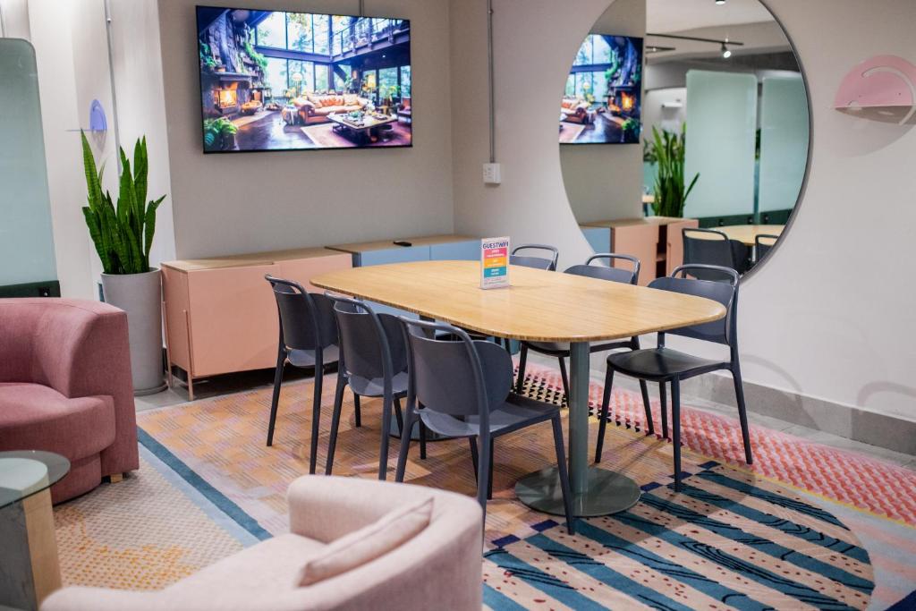 a table and chairs in a waiting room with a mirror at CampusKey Cape Town in Cape Town
