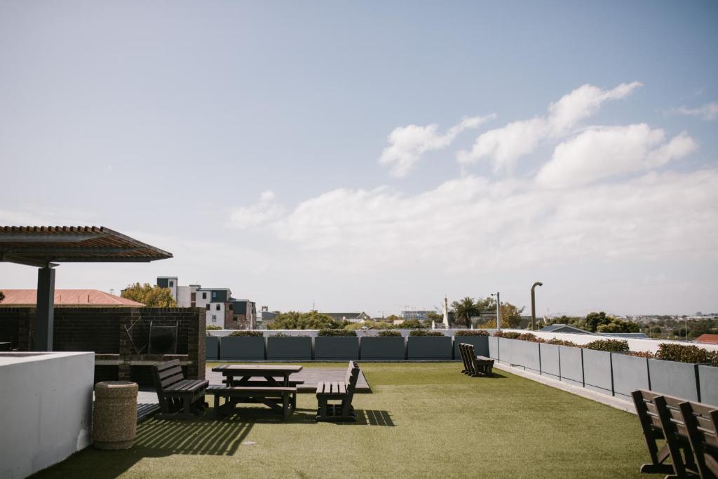 a patio with a table and chairs on a roof at CampusKey Cape Town in Cape Town