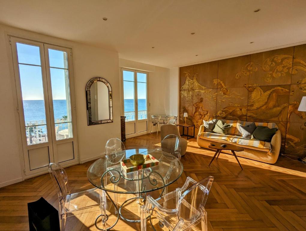 a living room with a couch and a table and chairs at Happyfew Palazzo del sol in Nice