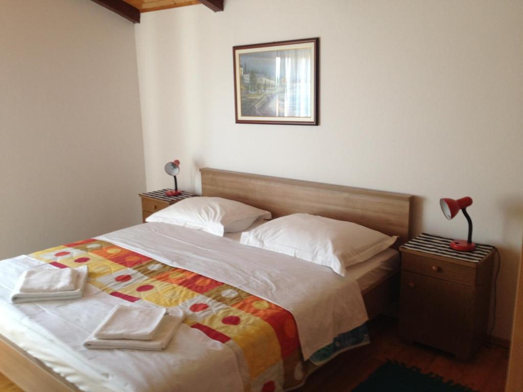 1 dormitorio con 1 cama y una foto en la pared en Apartments Mirela, en Poreč