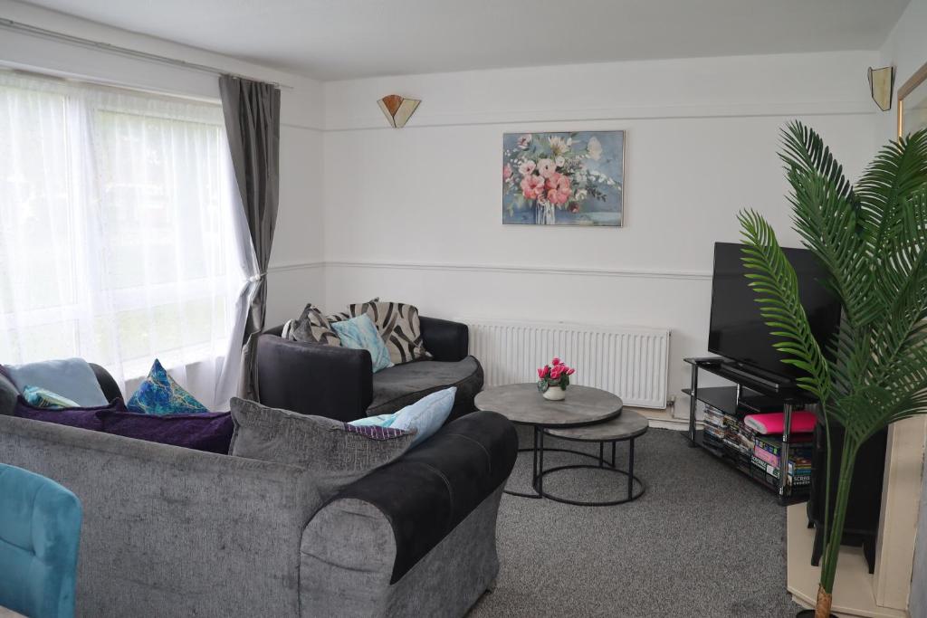 a living room with a couch and a table at Superb 3 Bedroom flat in Stafford in Stafford
