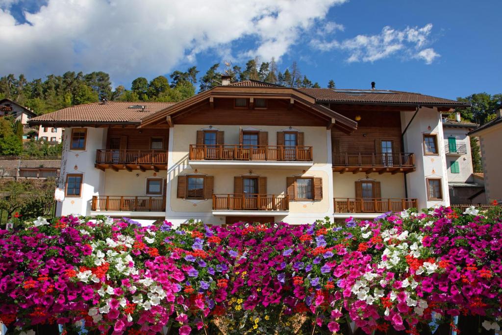 a house with flowers in front of it at Garni Manuela in Cavalese