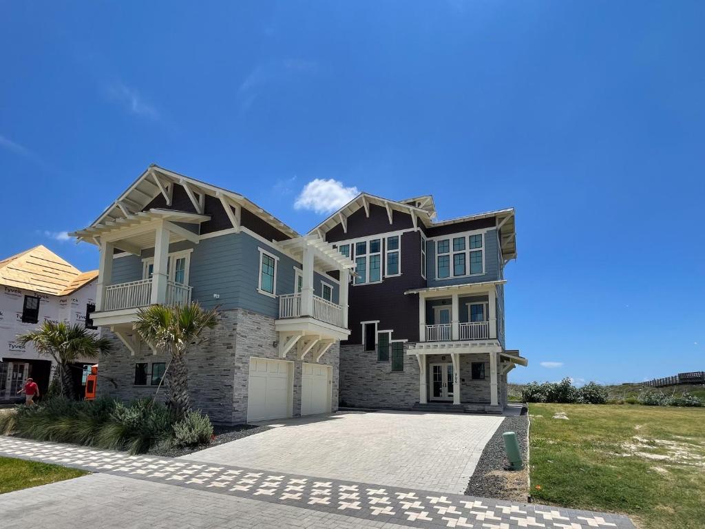 a large house with a driveway in front of it at SBSL706 Luxury, Ocean front beach house, Hot Tub, Boardwalk to Beach in Port Aransas