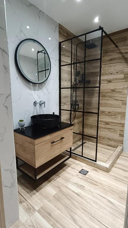 a bathroom with a black sink and a mirror at Comfort Corner Spacious & Quiet 2BR Apartment in Thessaloniki in Thessaloniki
