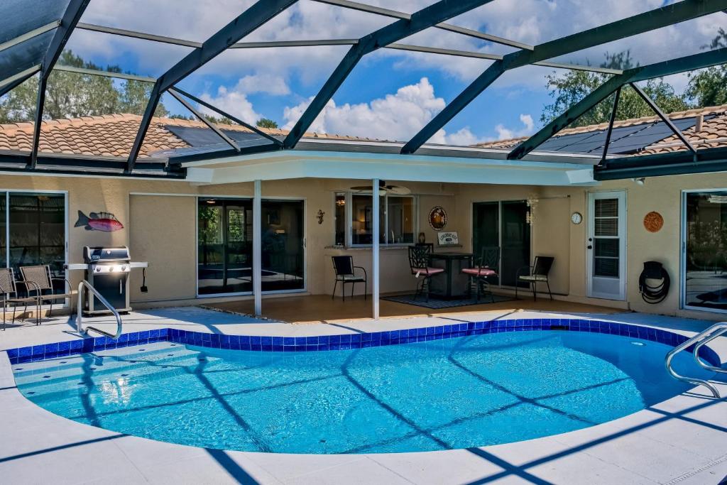 a swimming pool in a house with an open roof at Mermaid Shores in Sarasota