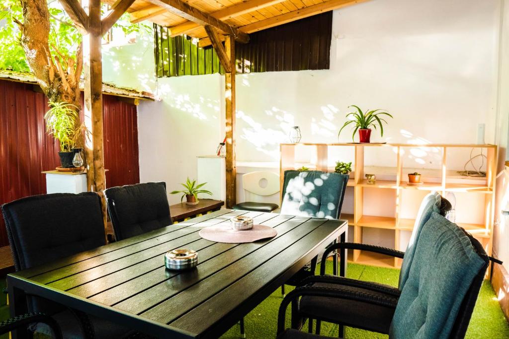 a wooden table and chairs in a room at HOSTEL SPORT BUCHAREST in Bucharest