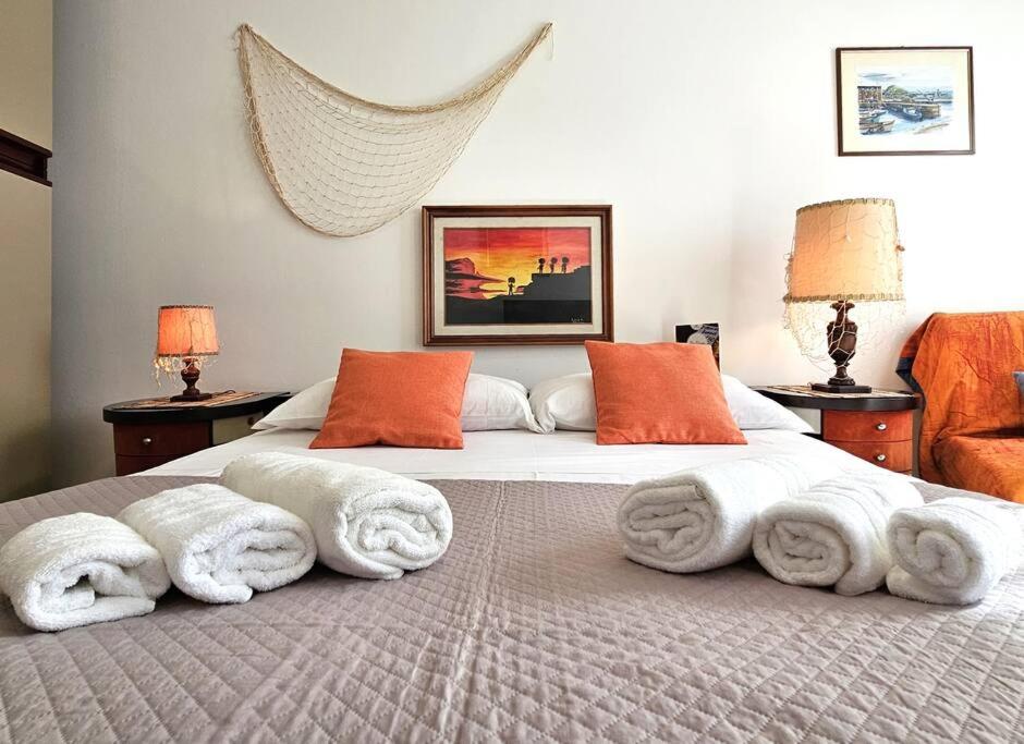 a bedroom with a large bed with towels on it at [ Portofino ] Centro di Rapallo in Rapallo