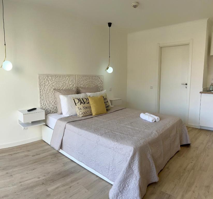 a bedroom with a large bed in a room at Feeling Like Home Machico in Machico