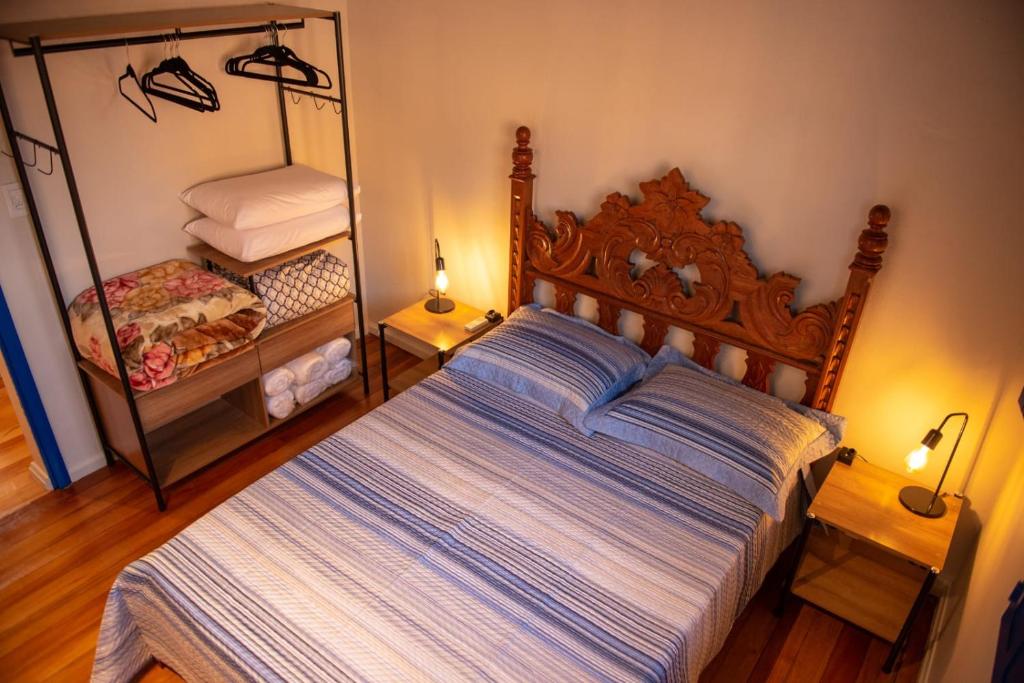 a bedroom with a large bed and a mirror at Pousada Nonno Fiorindo in Volta Grande