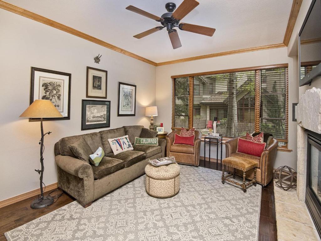 a living room with a couch and a fireplace at Arrowhead Village Condo - 104 Aspenwood Lodge in Edwards