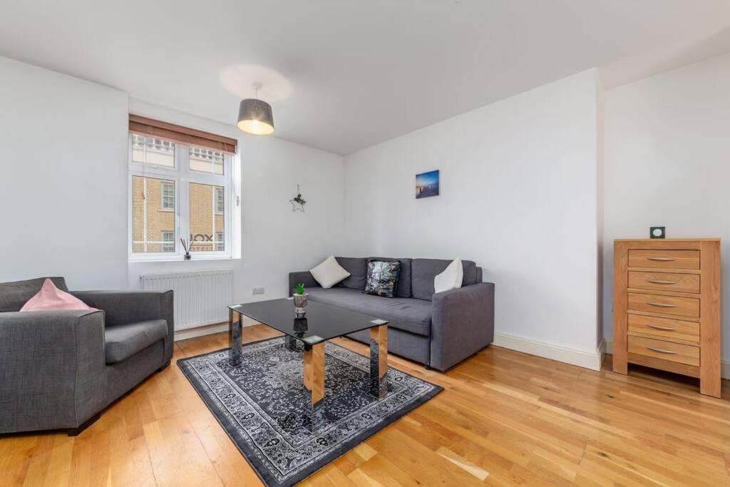 a living room with a couch and a table at Lovely 2 BR with patio Waterloo LM1 in London